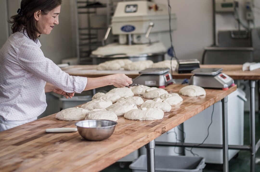 baker kneading bread dough